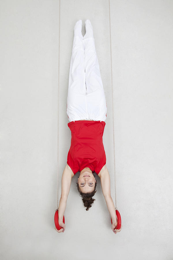 Woman exercising handstand on rings Photograph by Westend61