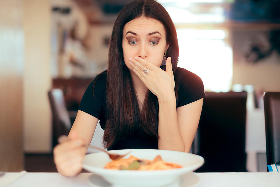 Woman Feeling Sick While Eating Bad Food in a Restaurant Photograph by Nicoletaionescu