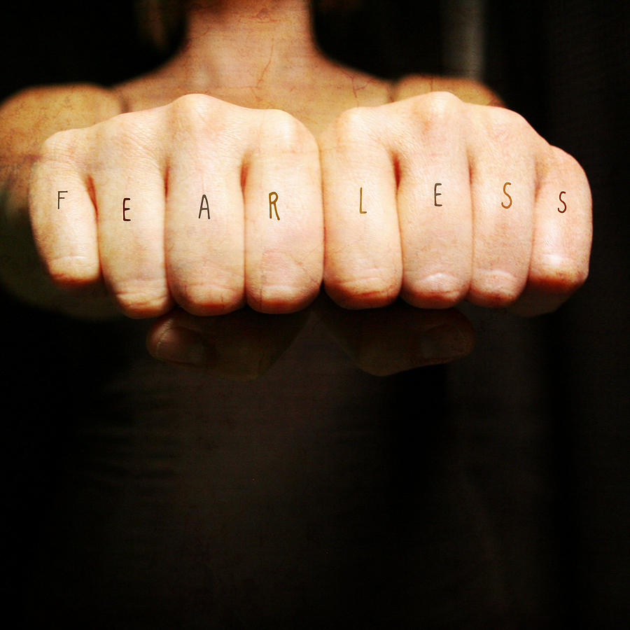 Woman fists with fearless across the knuckles Photograph by Erin Handley