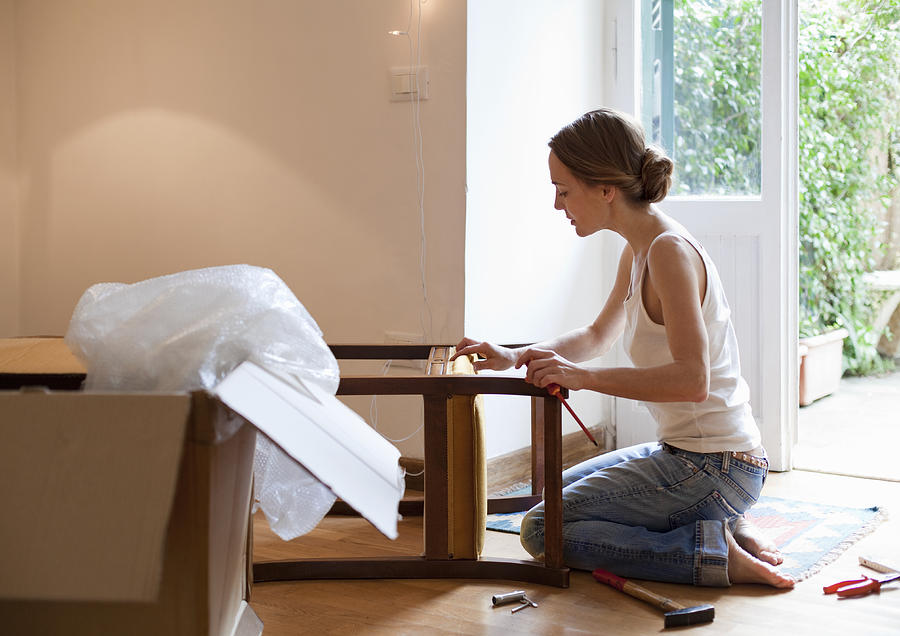 Woman Fixing Piece Of Furniture Photograph by Kathrin Ziegler