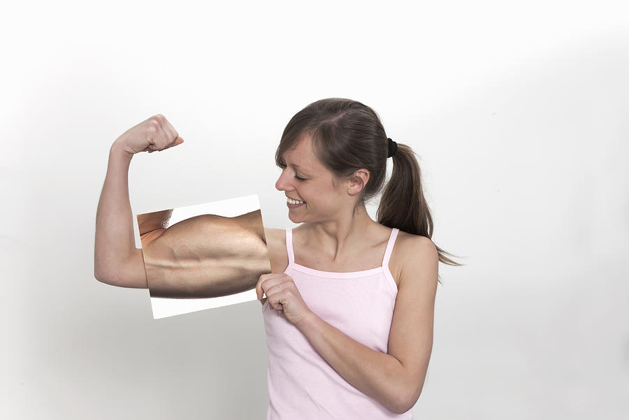 Woman Flexing Muscles Photograph by Buena Vista Images