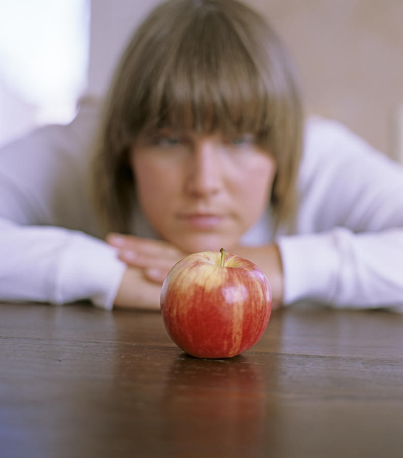 Woman, focus on apple Photograph by Daniel Krolls
