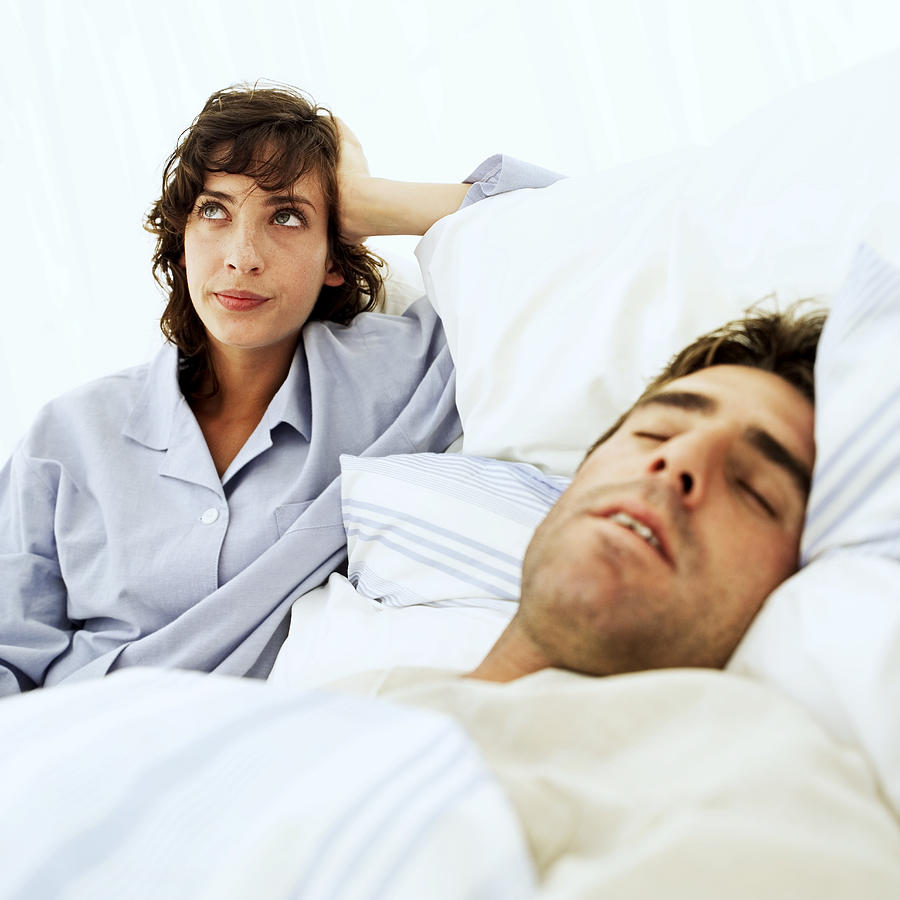 Woman Frustrated At Mans Snoring Photograph by Stockbyte