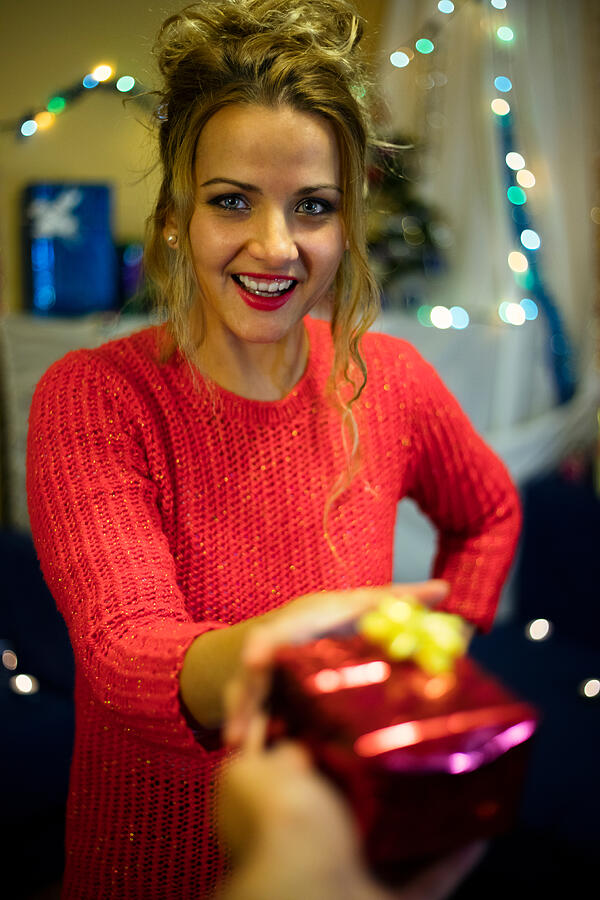 Woman giving a gift. Happy birthday. Happy New Year. Photograph by Viktor Cvetkovic
