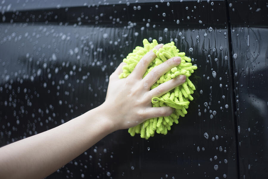 Woman Hand Hold A Brush Washing Over The Black Car Photograph by IttoIlmatar