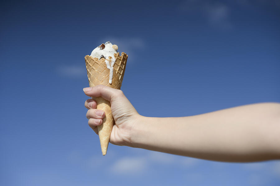 Woman Hand Holding Ice Cream Cone On A Hot Summer Photograph by IttoIlmatar