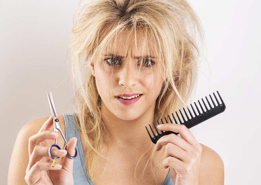 Woman having bad hair day with scissors and comb Photograph by Dimitri Otis