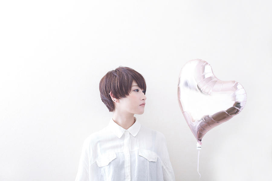 Woman having balloon of heart shape Photograph by Tadamasa Taniguchi