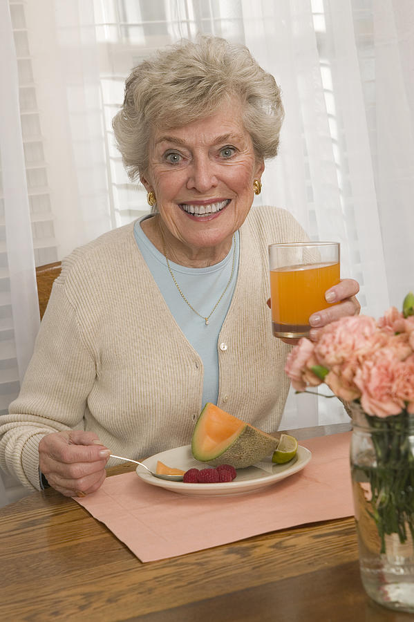 Woman having breakfast Photograph by Comstock Images