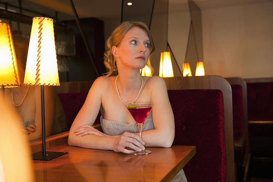 Woman having drink at restaurant Photograph by Judith Haeusler