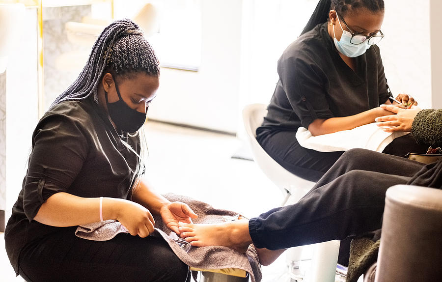 Woman having pedicure and manicure at beauty spa during pandemic Photograph by NickyLloyd