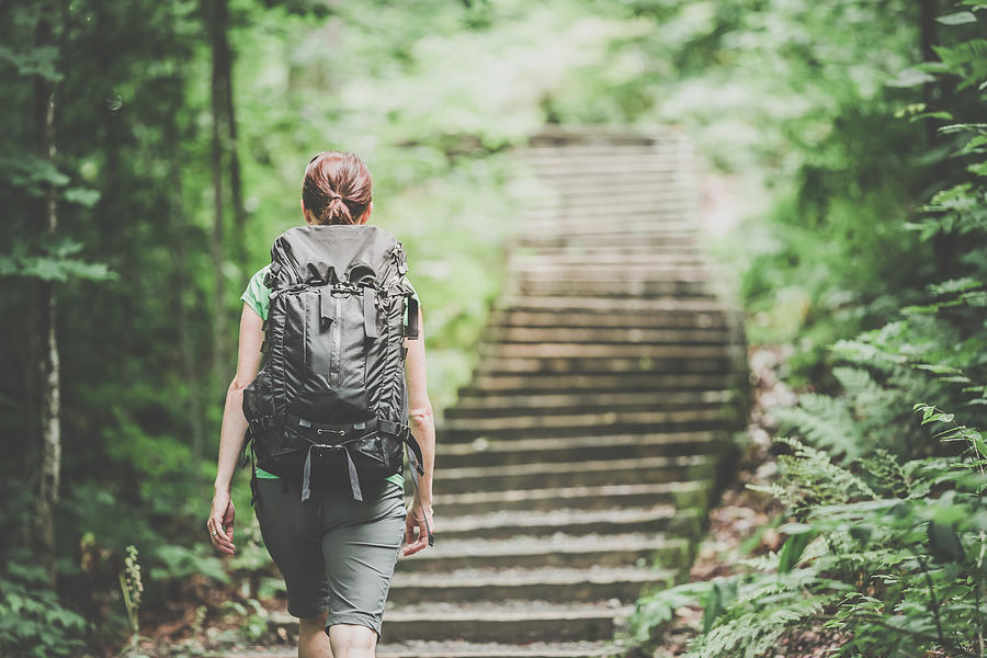 Woman Hiking Trekking with Backpack on Footpath in Forest Photograph by Onfokus