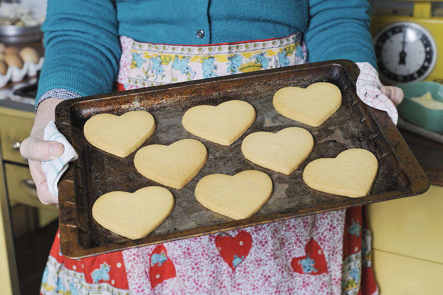 Woman holding a tray of heart shaped cookies Photograph by David Malan