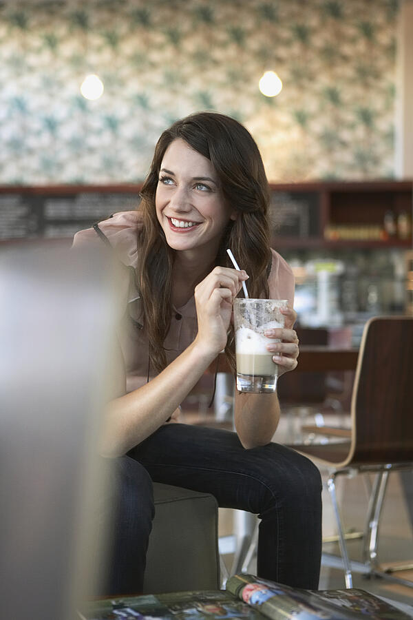 Woman holding coffee drink Photograph by Felix Wirth