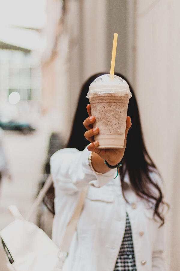 Woman Holding Coffee Milkshake At The Street Photograph by Carol Yepes