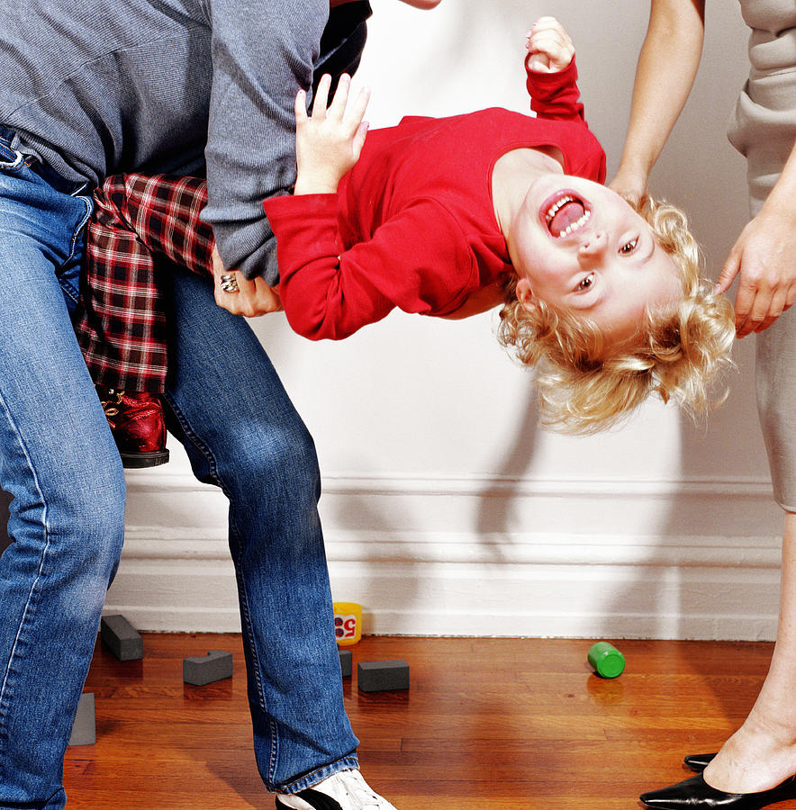 Woman holding girl (2-4) having tantrum, low section Photograph by Shannon Fagan