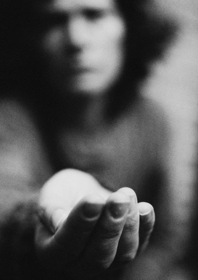 Woman holding hand out, blurred, b&w Photograph by Laurent Hamels