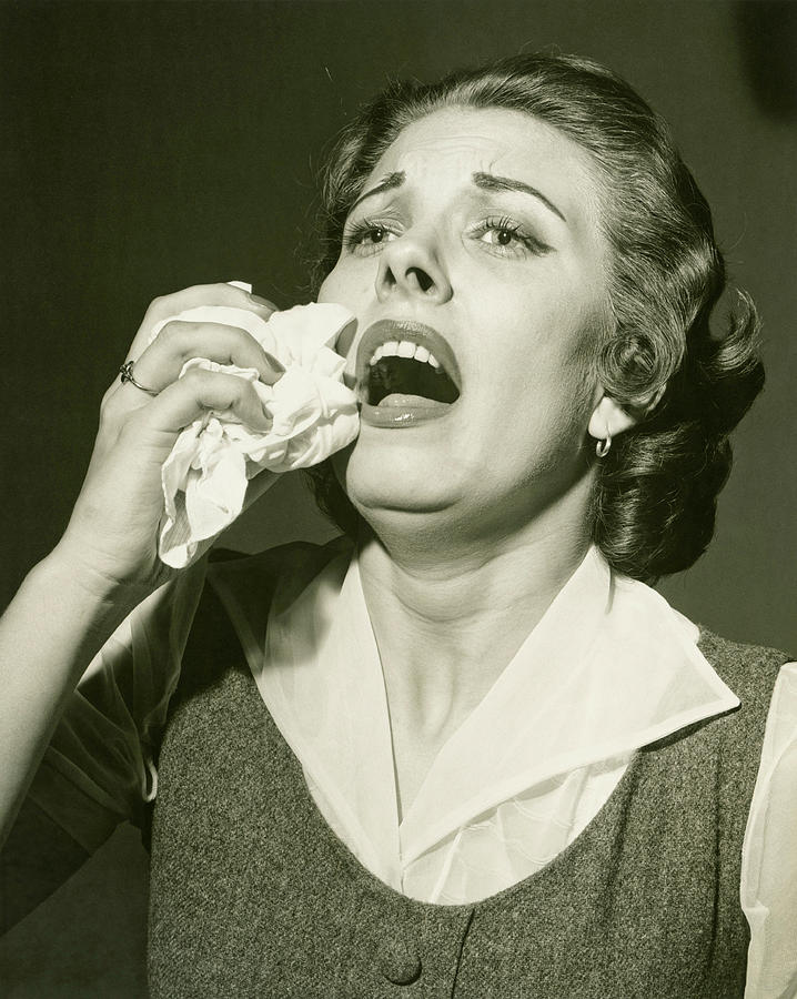 Woman holding handkerchief about to sneeze, (B&W), close-up Photograph by George Marks