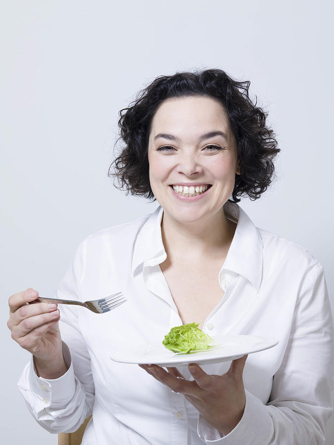 Woman Holding Plate With Leaf Of Salad Photograph by Maiwolf