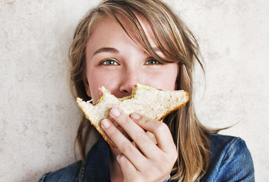 Woman Holding  Sandwich With Bites Taken From It Photograph by Dimitri Otis