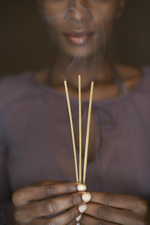 Woman holding three sticks of incense Photograph by Felix Wirth