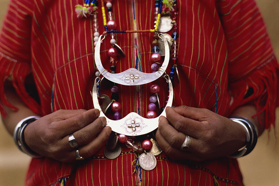 Woman holding tribal jewelry, Chiang Rai, Thailand Photograph by Dallas and John Heaton