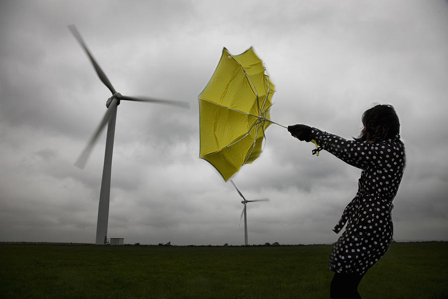 Woman Holding Umbrella Beneath Wind Turbines Photograph by Andrew Bret Wallis
