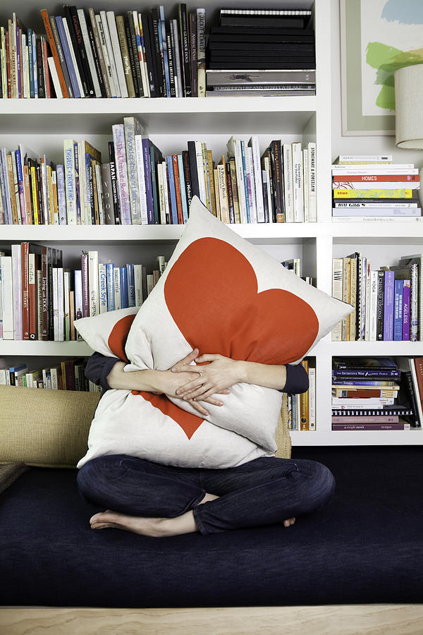 Woman Hugging heat pillows Photograph by Catherine Ledner