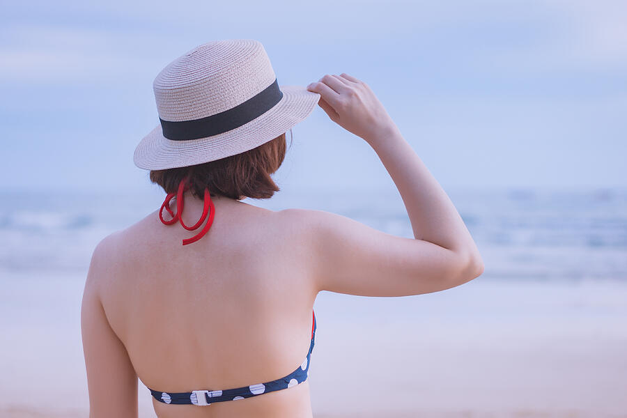 Woman in bikini and hat at the sea Photograph by Suphat Bhandharangsri Photography