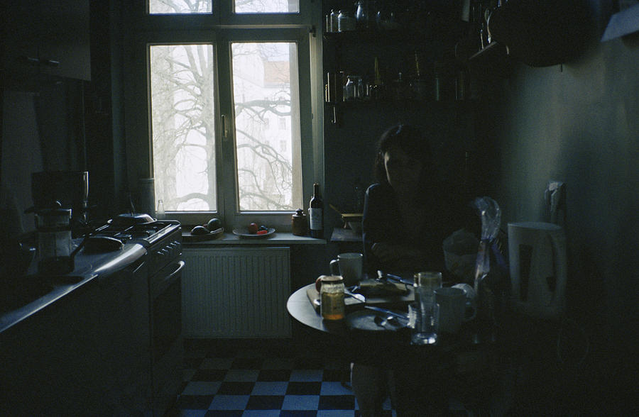 Woman in dark kitchen Photograph by Dejan