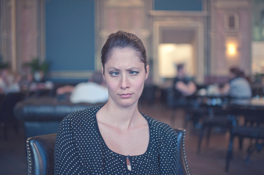 Woman in European cafe, crossed eyes Photograph by by Dornveek Markkstyrn