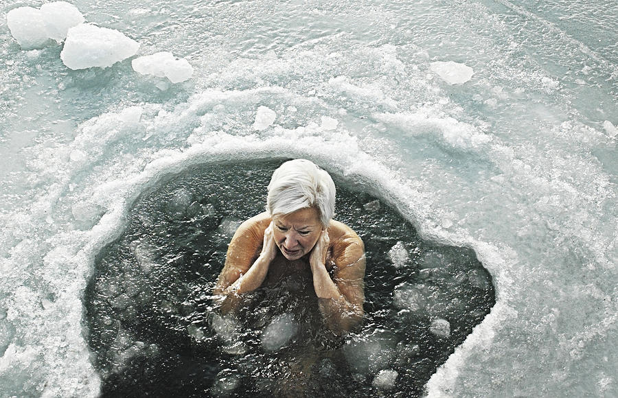 Woman in icy sea Photograph by David Trood