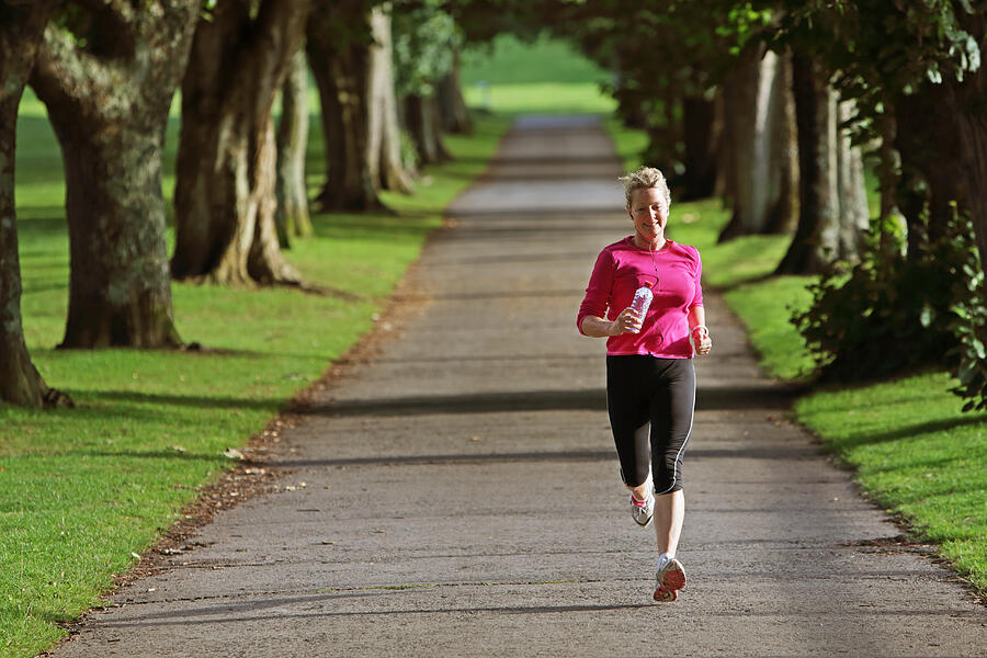 Woman In Pink Top Running Outside Trough Landscape Photograph by Peter Cade