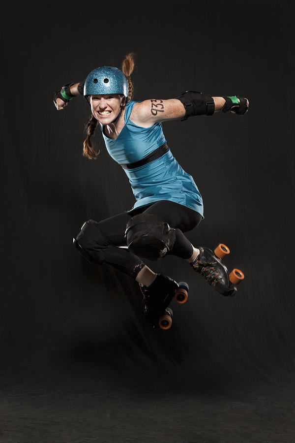 Woman in roller skates jumping Photograph by David Sacks