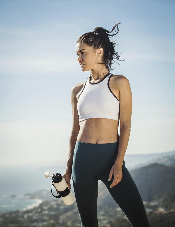 Woman in sportswear with water bottle Photograph by Erik Isakson