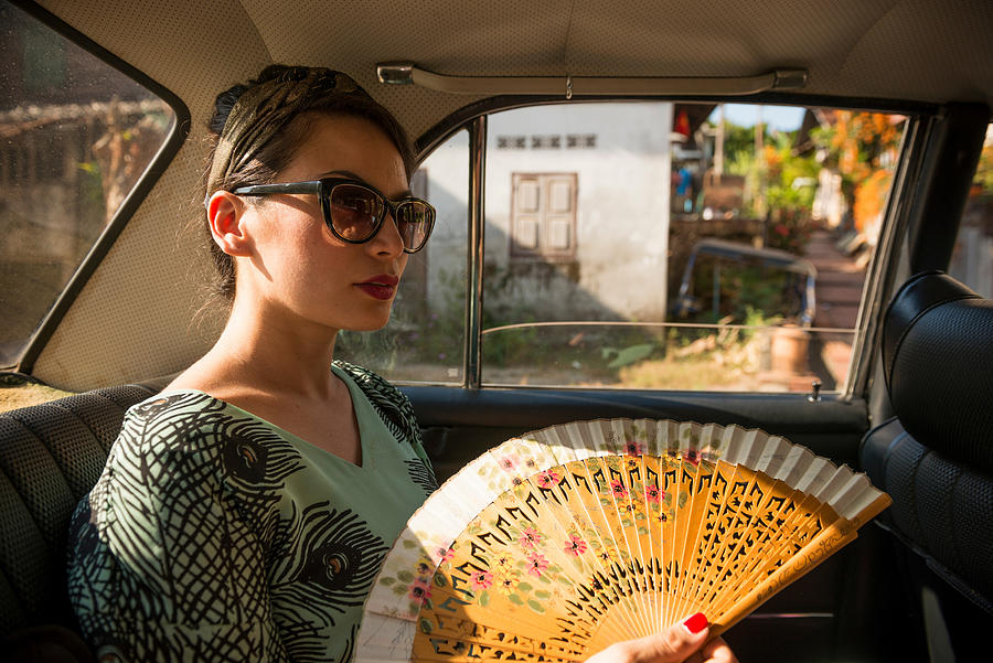Woman in taxi holding fan Photograph by Ben Pipe Photography