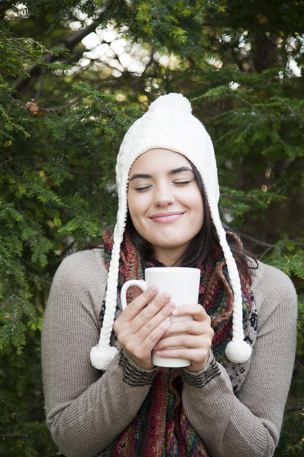 Woman in winter holding mug of hot chocolate Photograph by Jacqueline Veissid