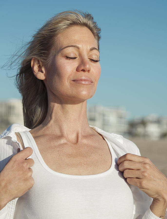 Woman inhaling fresh air at the beach Photograph by Stellalevi