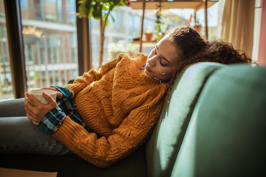 Woman is resting on the sofa in her apartment Photograph by DaniloAndjus