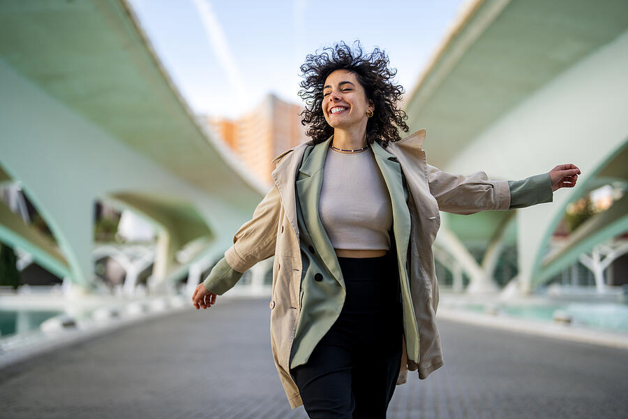 Woman jumping high after successful job interview Photograph by Ljubaphoto Woman jumping high after successful job interview Photograph by Ljubaphoto