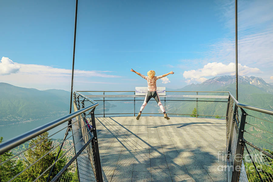Woman jumps on Aussichtsplattform Cardada platform Photograph by Benny Marty
