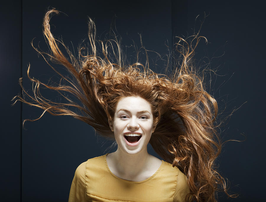 Woman Laughing With Her Hair Blowing In Wind. Photograph by Betsie Van der Meer
