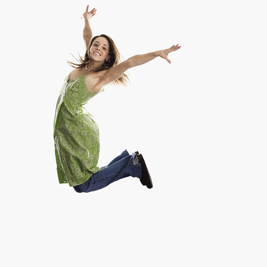 Woman leaping into air Photograph by Brand X Pictures