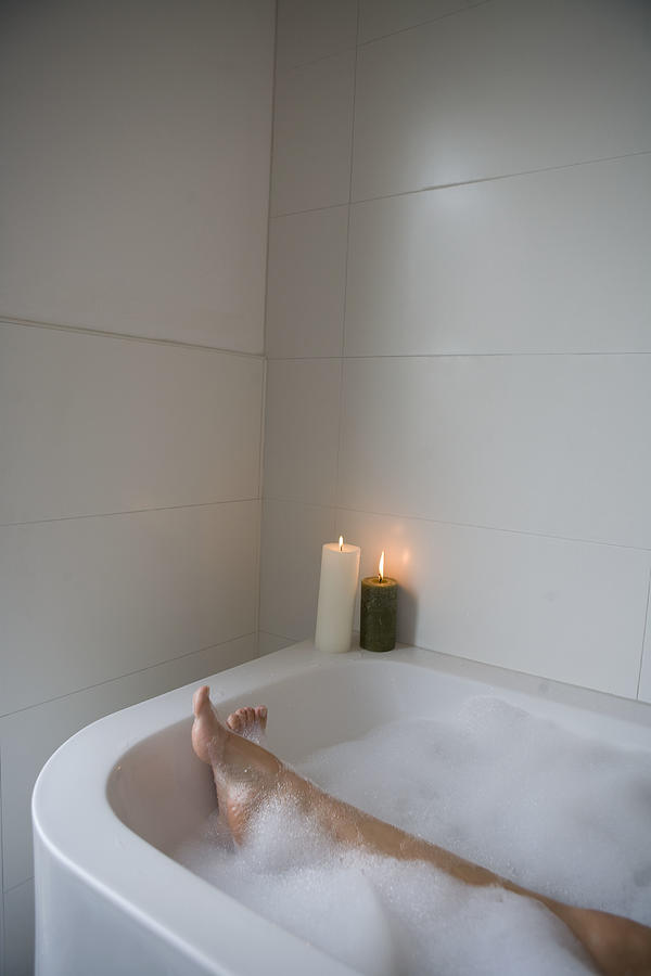 Woman legs in bathtub Photograph by Britt Erlanson