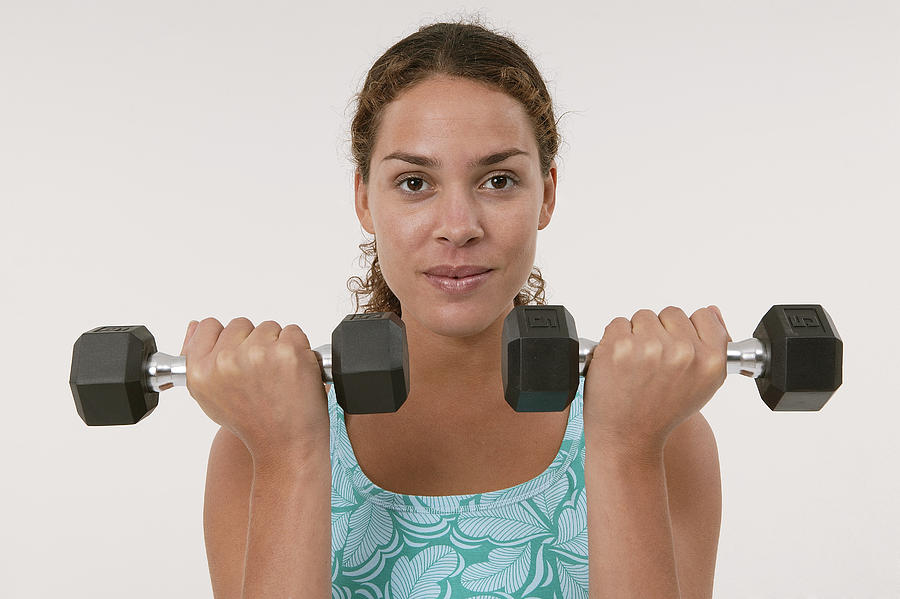 Woman lifting weights Photograph by Comstock Images