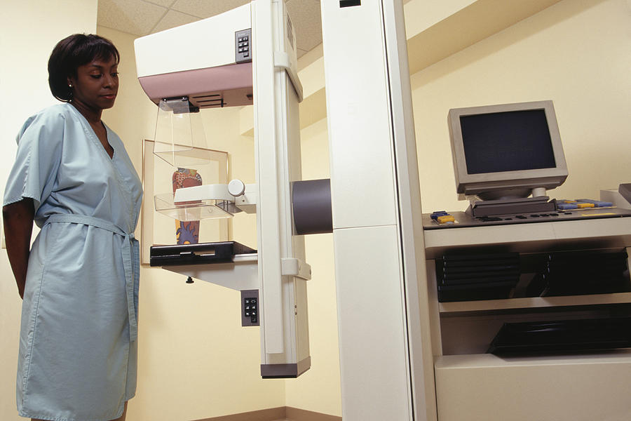 Woman looking at mammogram machine Photograph by Keith Brofsky