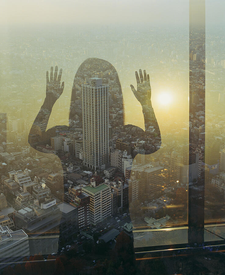Woman looking out at cityscape, rear view (double exposure) Photograph by Jasper James