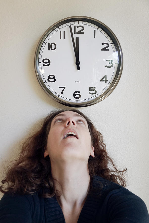 Woman looking up at a clock, close to noon Photograph by Melinda Podor