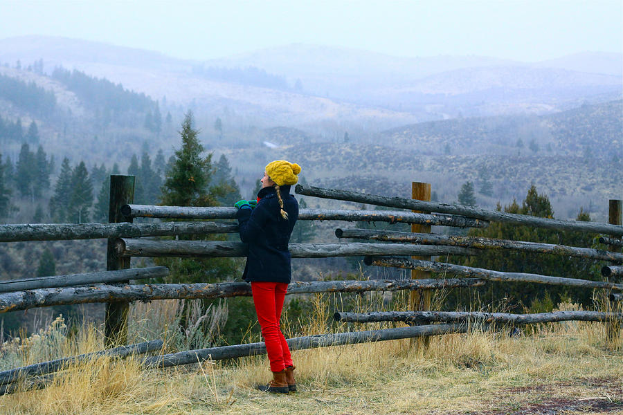 Woman looks out over rail fence Photograph by Jillian Lukiwski