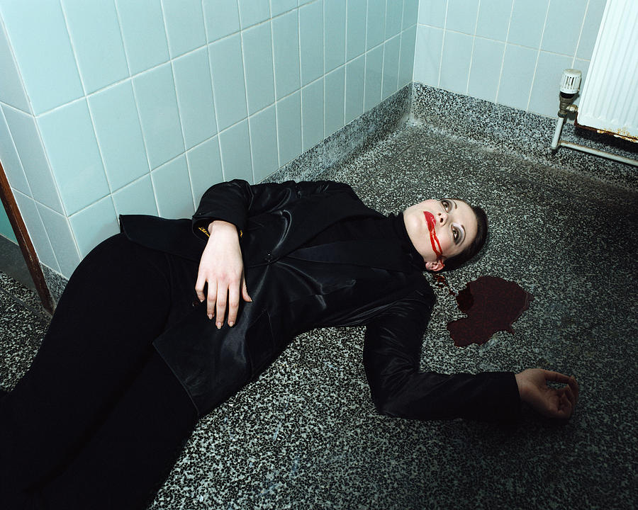 Woman lying dead on the floor Photograph by Image Source